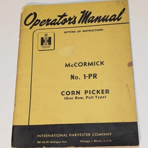 May include: A vintage McCormick No. 1-PR Corn Picker operator's manual. The cover is yellow with black text and a black band at the bottom. The International Harvester logo is visible.