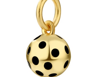 May include: A gold charm with a black polka dot pattern. The charm is in the shape of a sphere with a small loop at the top for attaching to a bracelet or necklace.