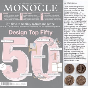 May include: A magazine cover featuring a pink and white illustration of the number 50, with the words "Design Top Fifty" above it. The cover also features illustrations of various design elements, including a chair, a motorcycle, a skateboard, a kitchen sink, and a dog. The cover also includes the text "It's time to rethink, redraft and refine" and "Design Awards 2023".