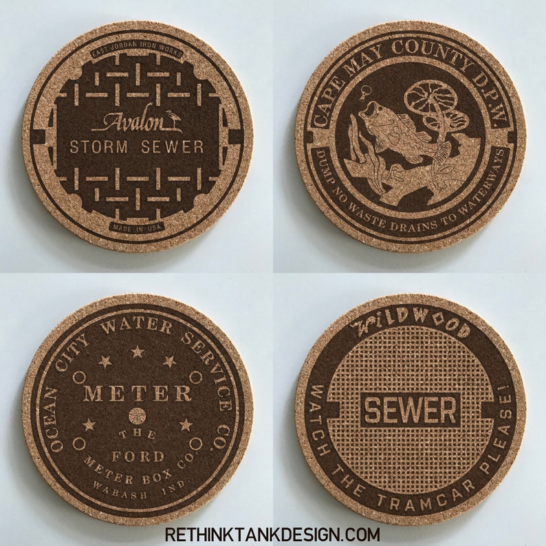 May include: Four round cork coasters with different designs. The first coaster has a brown and black design with the text "Avalon Storm Sewer" and "Made in USA". The second coaster has a brown and black design with the text "Cape May County D.P.W. Dump No Waste Drains to Waterways". The third coaster has a brown and black design with the text "Ocean City Water Service Co. Meter The Ford Meter Box Wabash Ind.". The fourth coaster has a brown and black design with the text "Wildwood Watch The Tramcar Please Sewer".