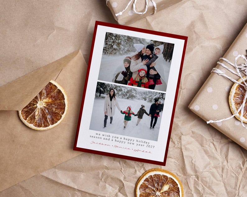 May include: A rectangular holiday greeting card with a dark red border featuring two stacked photographs of a family in a snowy landscape. The card includes the printed text: we wish you a happy holiday season and a happy new year 2027.