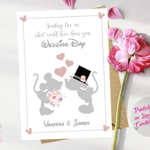 May include: A gray and pink wedding card with a silhouette of Mickey and Minnie Mouse. The card says "Sending love on what would have been your Wedding Day" and is signed "Vanessa & James".