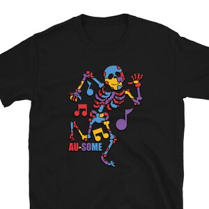 May include: Black t-shirt with a colorful skeleton graphic dancing with musical notes. The text "AU-SOME" is printed below the skeleton.