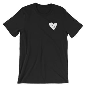 May include: Black t-shirt with a white heart design featuring the letters "MS" inside.