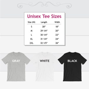 May include: Unisex tee shirt size chart with measurements in inches. The chart shows the size, length, and width of the shirts in sizes S, M, L, XL, and 2XL. Three tee shirts are shown below the chart: one gray, one white, and one black.