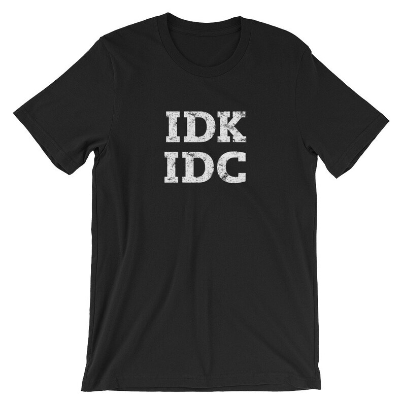 May include: Black t-shirt with white text that reads "IDK IDC" in a distressed font.