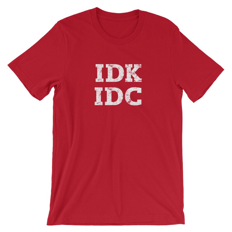 May include: Red short-sleeved t-shirt with the text "IDK IDC" in white distressed lettering.