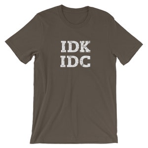 May include: A dark brown t-shirt with a white distressed graphic that says "IDK IDC".