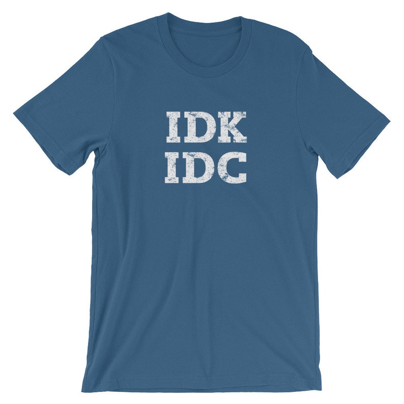 May include: A blue t-shirt with the text "IDK IDC" in white distressed lettering.