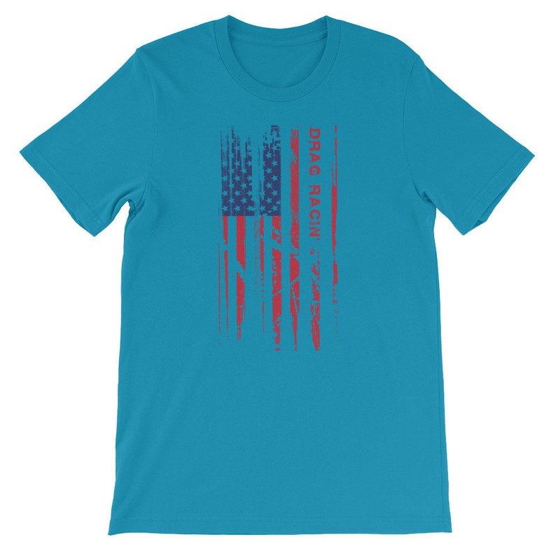 May include: A turquoise blue t-shirt featuring a distressed American flag design and the text "DRAG RACIN'" in red.