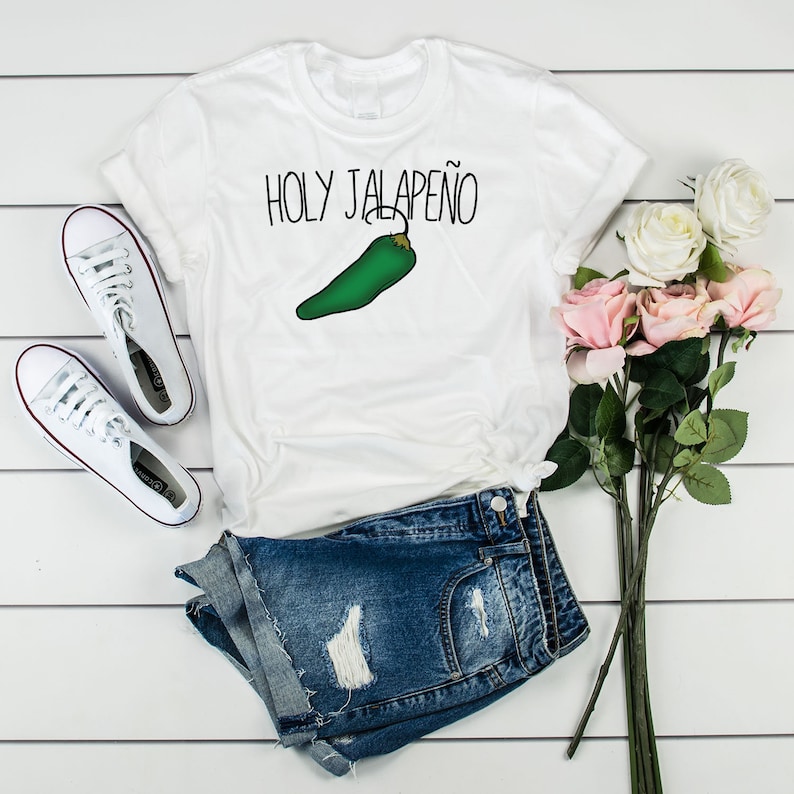 May include: White t-shirt with the text "HOLY JALAPE&Ntilde;O" and a green jalapeno pepper graphic.