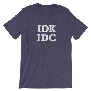 May include: A navy blue t-shirt with the text "IDK IDC" printed in white on the front.