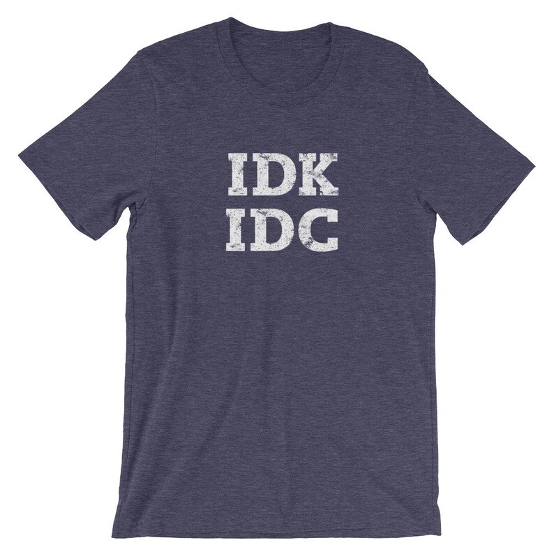May include: A navy blue t-shirt with the text "IDK IDC" printed in white on the front.