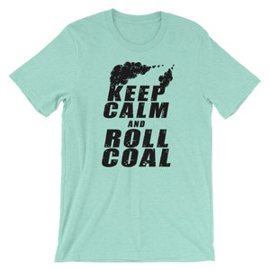 May include: A light blue t-shirt with a black graphic print of a train engine with smoke coming out of the chimney. The text "Keep Calm and Roll Coal" is printed below the image.