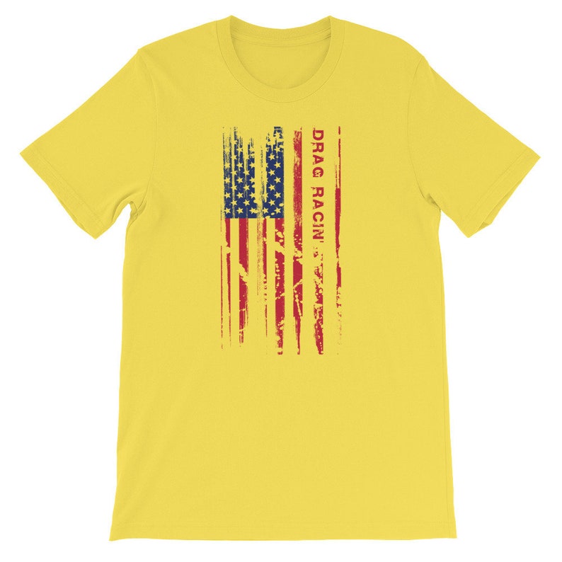 May include: Yellow short-sleeved t-shirt featuring a distressed American flag design and the text "DRAG RACIN'" in red.