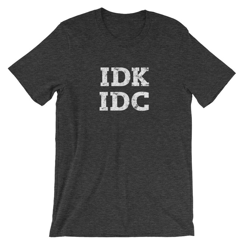 May include: Dark heather grey t-shirt with white text that reads "IDK IDC" in a distressed font.