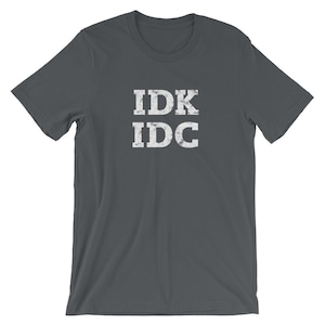 May include: Dark gray t-shirt with white text that reads "IDK IDC" in a distressed font.