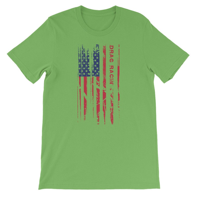May include: A green t-shirt featuring a distressed American flag design and the text "DRAG RACIN'" in red.