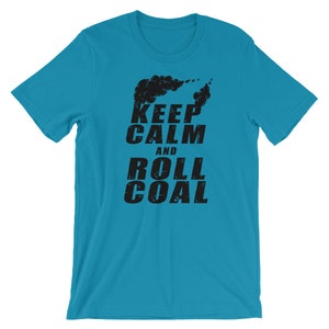 May include: A turquoise blue t-shirt with a black graphic print of a train engine with smoke coming out of the chimney. The text on the shirt reads "Keep Calm and Roll Coal".