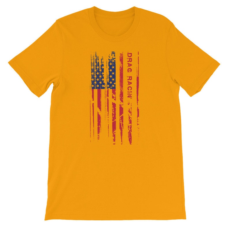 May include: A yellow t-shirt featuring a distressed American flag design and the text "DRAG RACIN'" in red.