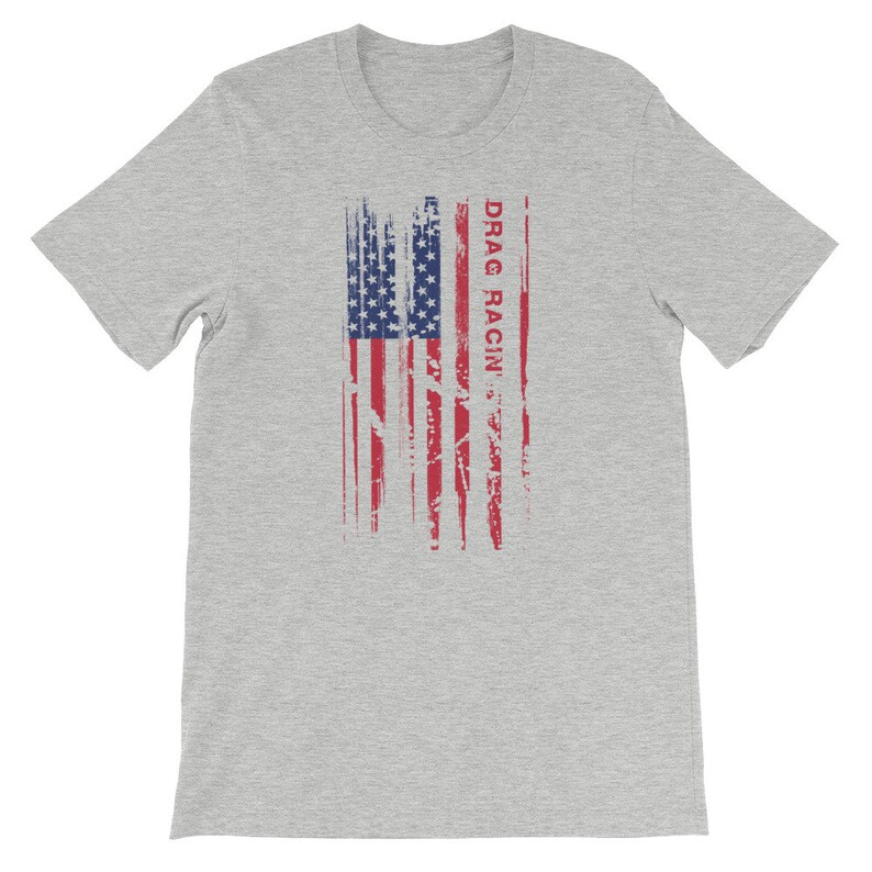May include: A heather grey t-shirt featuring a distressed American flag design and the text "DRAG RACIN'" in red.