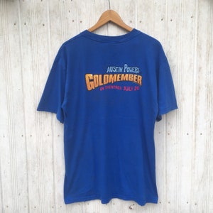 Vintage Austin Powers Goldmitglied Kaufen Sie ein Getränk, zahlen Sie das Spiel ”Britisches Spion-Aktions-T-Shirt Größe groß