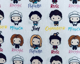 May include: A white fabric featuring a repeating pattern of cartoon characters from the television show Friends. The print includes chibi-style illustrations of Rachel, Phoebe, Ross, Joey, Monica, and Chandler, each with their name printed below.