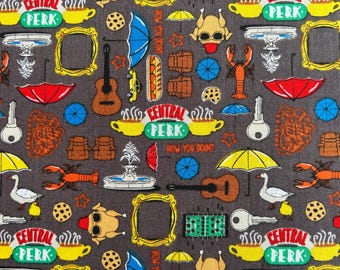 May include: A dark gray fabric featuring a repeating pattern of icons including yellow Central Perk coffee cups, orange lobsters, yellow picture frames, acoustic guitars, red umbrellas, white geese, keys, foosball tables, and turkeys.