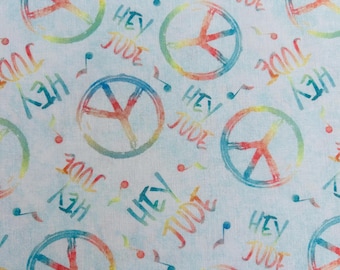 May include: A light blue fabric featuring a repeating pattern of multicolored peace signs and the text Hey Jude in a watercolor style. Small musical notes are scattered throughout the design, creating a rhythmic and vibrant visual composition.