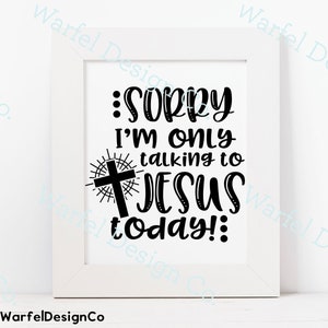 May include: A white framed print with black text that reads "Sorry I'm only talking to Jesus today!" with a cross and sunburst design.