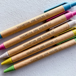 May include: Six brown cardboard pens with different colored tips. Each pen has the text "REDEMPTION JUNK HAULING LLC" printed on it.