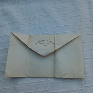 May include: A white envelope with the text "The Hongkong and Shanghai Banking Corp. London." printed on the front.