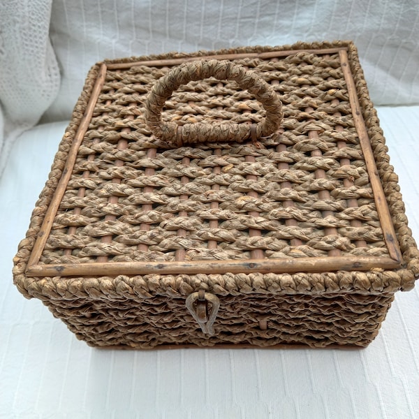 Vintage plaited sea grass sewing basket. Fully lined. Complete and sound with minor damage to sea grass and cane trim. Exterior discoloured.