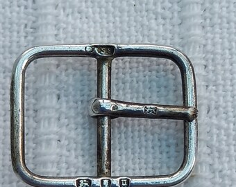 Vintage (1935?) or antique (1915?) silver buckle. Fully hallmarked, including maker's mark (SS?). Approx. 2.9 cm x 1.5 cm. For watch strap?