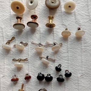 Small group of vintage (antique?) waistcoat buttons, with cotter pins, boot buttons, collar studs and buttons. Various ages and materials.