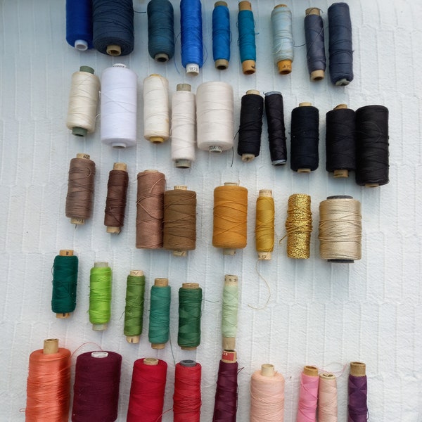 Job lot of forty-two vintage threads on cardboard spools. Different weights and colours. Cotton, polyester & possibly silk. Brands unknown.