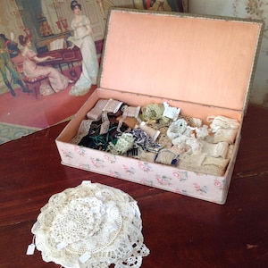 large antique fabric box with a huge lot of lace