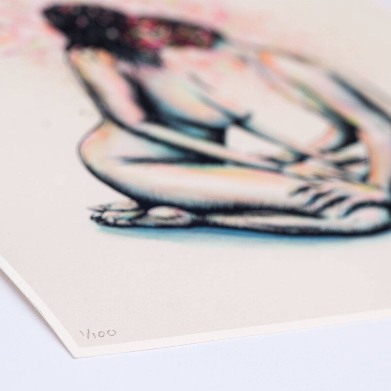 May include: A print of a seated figure, rendered in soft pencil strokes with a focus on the body's form. The artwork features a muted color palette with hints of pink and blue. The print is numbered 1/100.