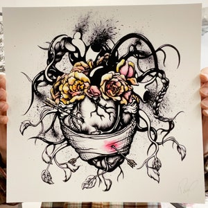 12x12" art print held up for scale purposes. The print features vibrant color on archival paper.