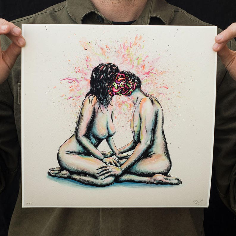 May include: An artistic print depicting two nude figures in an embrace, their faces merging into a colorful explosion of pink, orange, and yellow. The figures are seated, with hands clasped, against a white background.