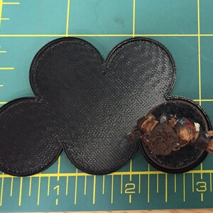 May include: Black 3D printed base with a five-pointed star shape. The base is approximately 2 inches in diameter.