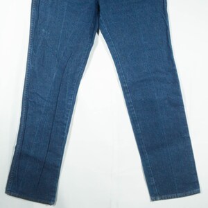 May include: A pair of blue denim jeans. The jeans have a classic five-pocket design, a straight leg, and a medium wash. The jeans are made of a durable denim fabric and are suitable for everyday wear.