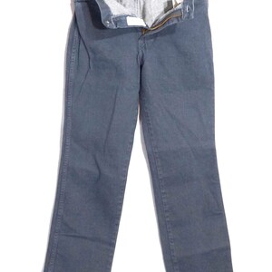 May include: A pair of dark gray denim jeans, displayed on a hanger. The jeans have a classic five-pocket design, a zipper fly, and a button closure. The fabric appears to be a medium-weight denim.