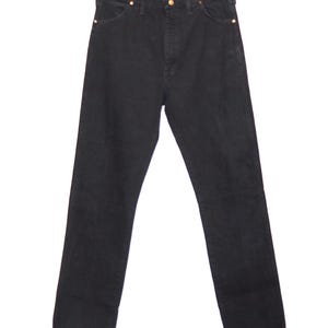 May include: Black denim jeans with a classic five-pocket design. The jeans have a straight leg cut and are hung on a metal hanger. The rivets and button are a gold color.