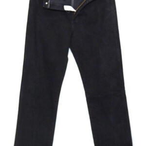 May include: Black denim jeans with a button and zipper closure. The jeans are hanging on a hanger against a white background. The jeans have a classic five-pocket design and a straight leg.