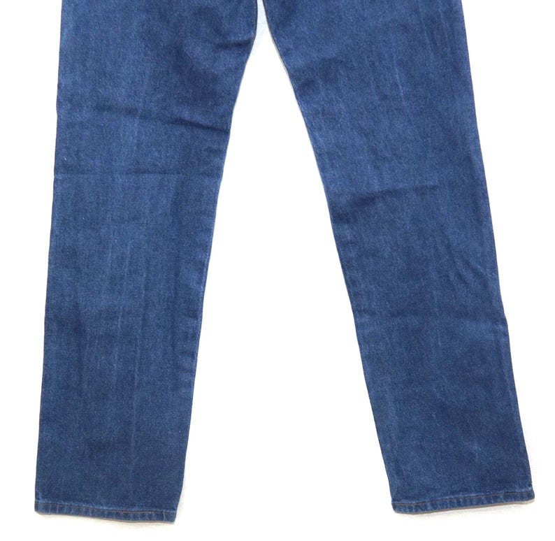 May include: A pair of blue denim jeans. The jeans have a classic five-pocket design and a straight leg cut. The denim has a medium wash with subtle fading and wear marks.