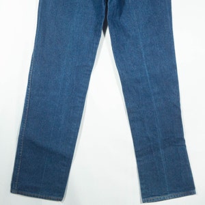 May include: A pair of blue denim jeans. The jeans have a classic five-pocket design, with a straight leg cut. The denim is a medium wash, and the jeans appear to be new or in excellent condition. The jeans are displayed against a white background.