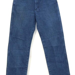 May include: Blue denim jeans with a classic five-pocket design. The jeans are hung on a vintage patterned hanger. The jeans have a straight leg cut and a button and zipper closure. The denim has a medium wash.