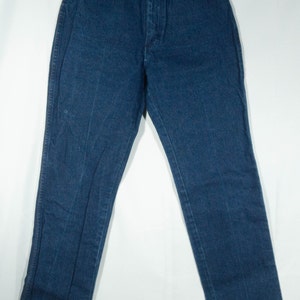 May include: Dark blue denim jeans with a high waist and straight leg. The jeans have classic five-pocket styling, copper rivets, and a button and zipper closure. The garment is hanging on a clear hanger against a white background.