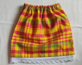 May include: A yellow, pink, and green plaid skirt with an elastic waistband and a white lace trim at the hem. The skirt is made of a lightweight fabric.